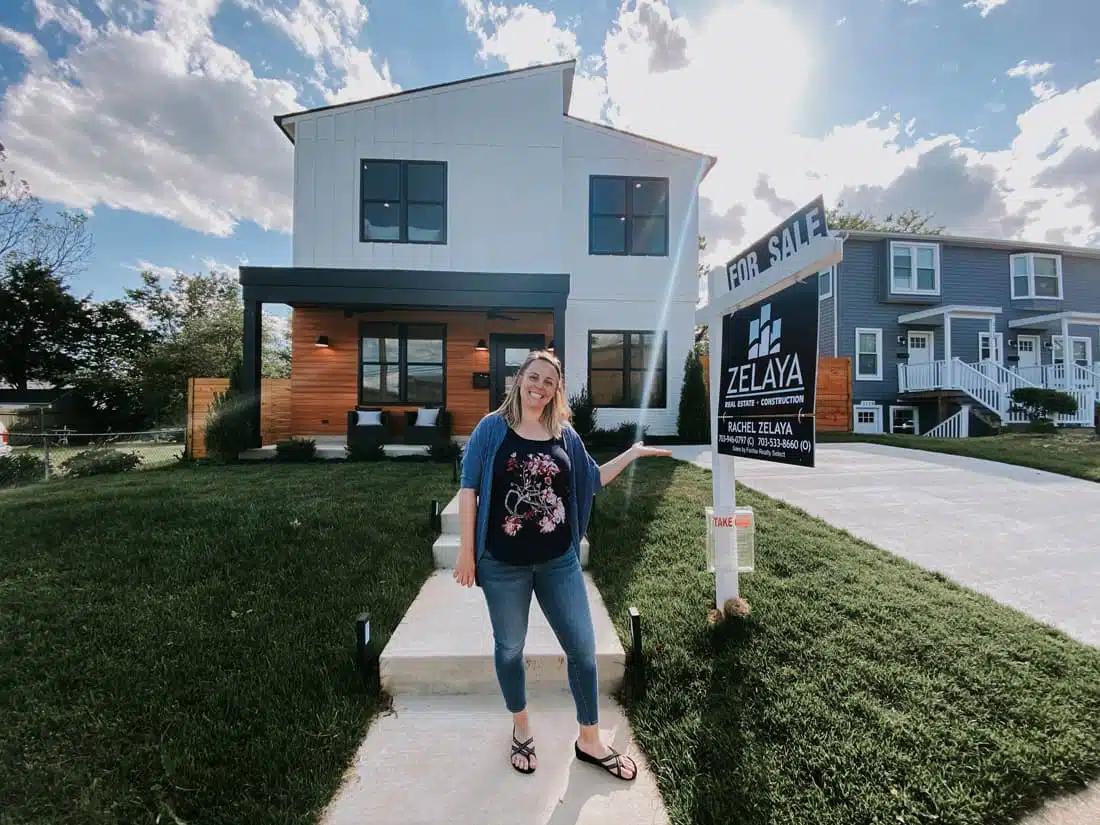 rachael-zelaya-outside-of-a-house-in-front-of-a-for-sale-sign